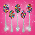 Four silver blinged-out ice cream scoop spoons with colorful jewel-toned beads on a hot pink glitter background